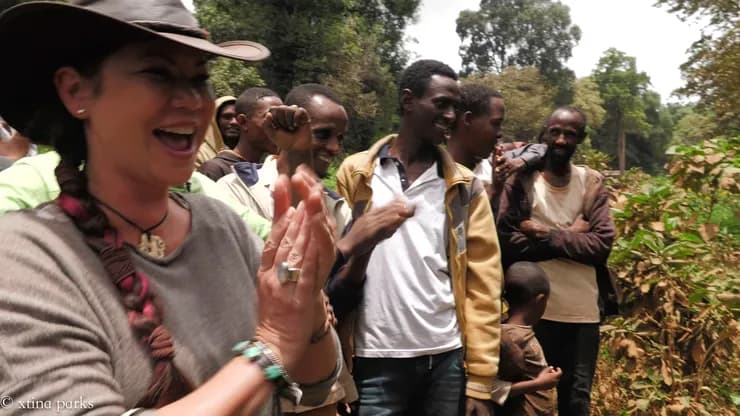 Xtina Parks clapping alongside community partners in the field